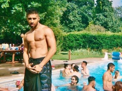 Chaneil Kular is topless in the picture and is on his swimming trunks.